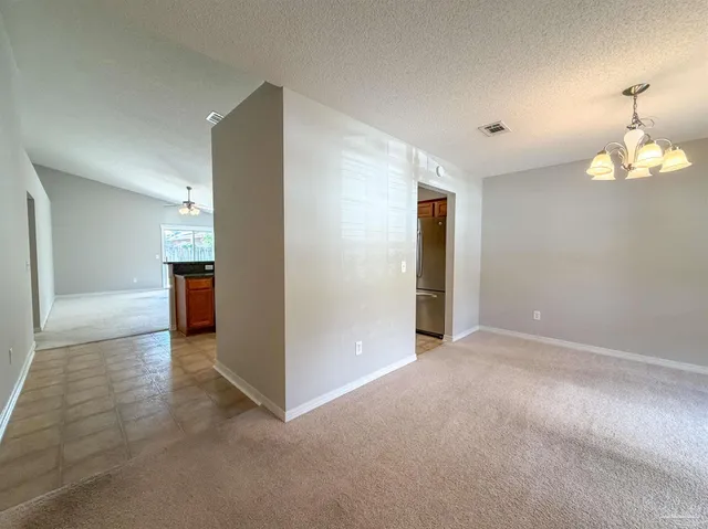 an empty room with closet and windows