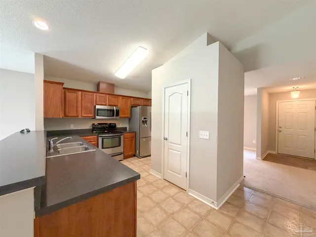 a kitchen with stainless steel appliances a refrigerator and a stove top oven