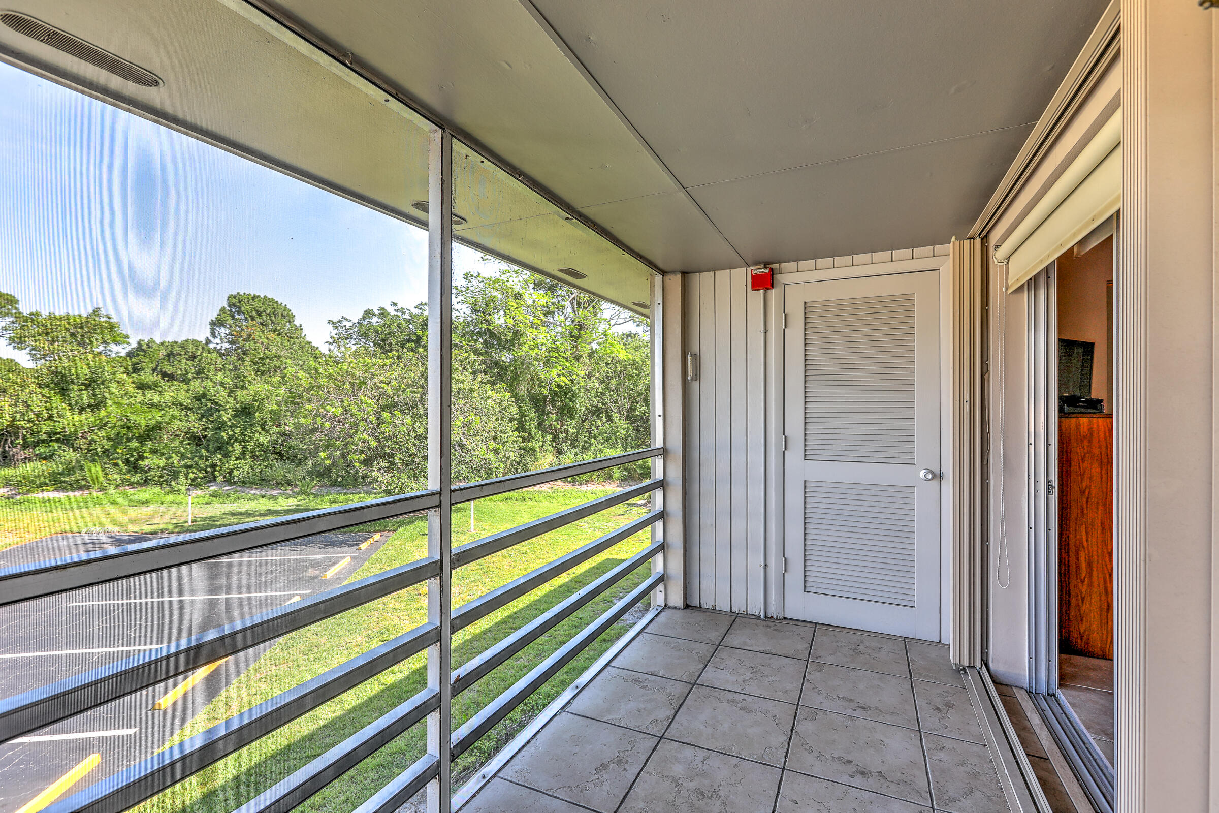 25 Lake Vista Trail, Unit 203 Port St. Lucie, FL 34952 - Photo 22 of 36 a view of empty room with wooden floor and fan