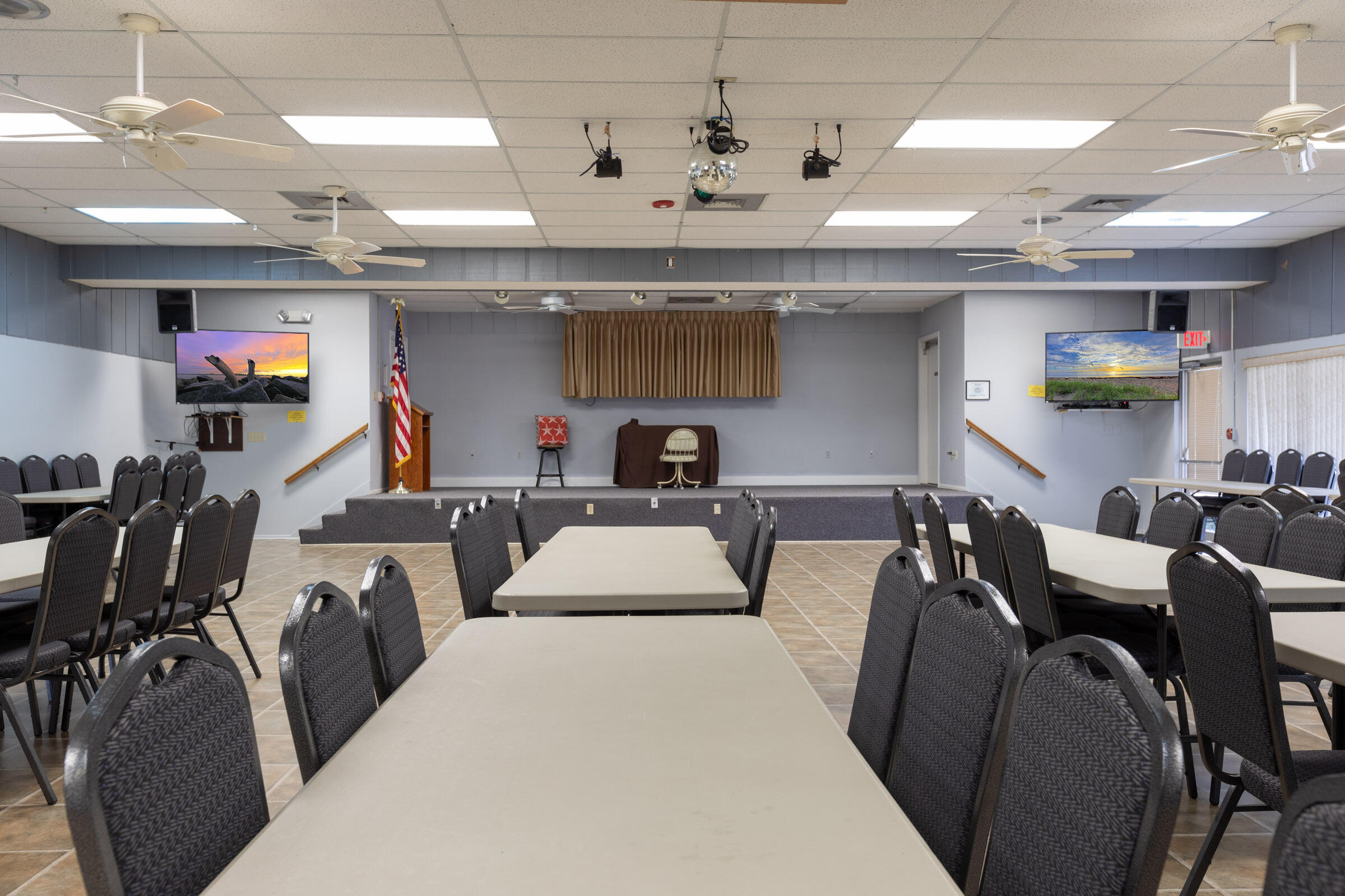 25 Lake Vista Trail, Unit 203 Port St. Lucie, FL 34952 - Photo 28 of 36 a living room with furniture a chandelier and a flat screen tv