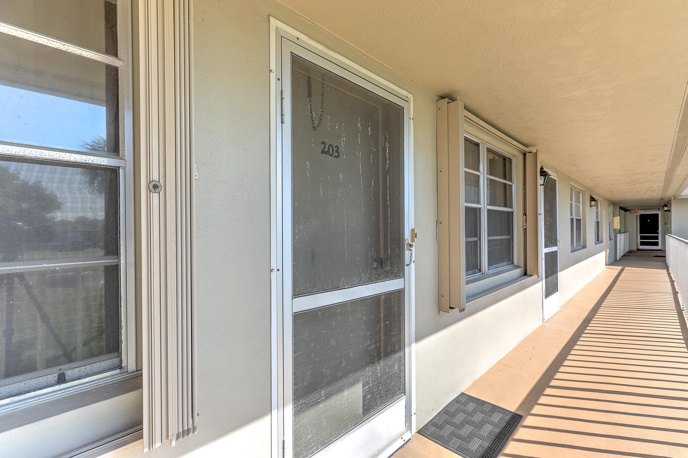 25 Lake Vista Trail, Unit 203 Port St. Lucie, FL 34952 - Photo 5 of 36 a hallway with wooden floor