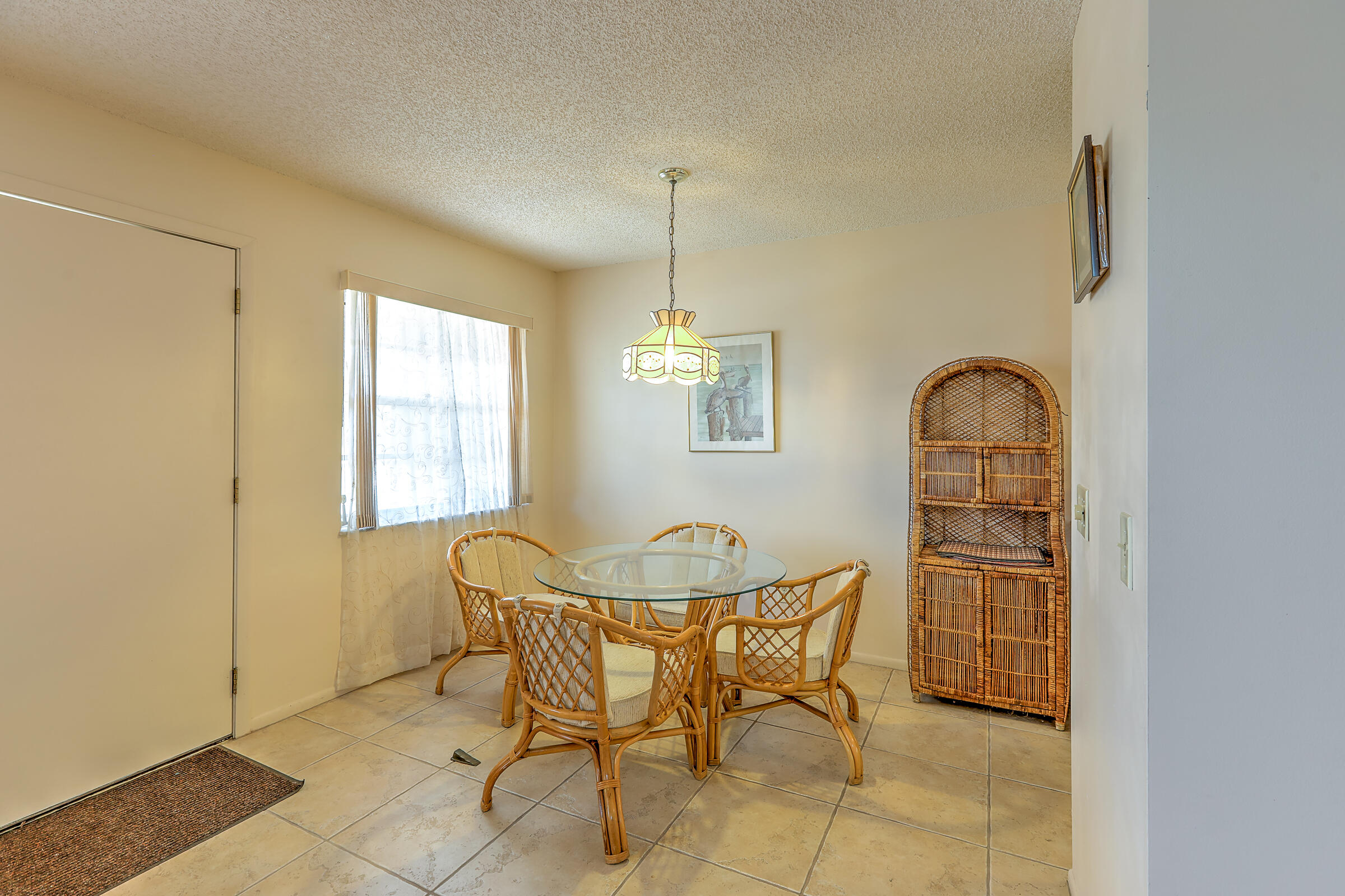 25 Lake Vista Trail, Unit 203 Port St. Lucie, FL 34952 - Photo 10 of 36 a dining room with furniture and window