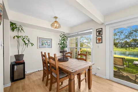a view of a dining room with furniture a chandelier and wooden floor