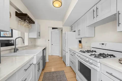 a kitchen with stainless steel appliances a sink stove and refrigerator
