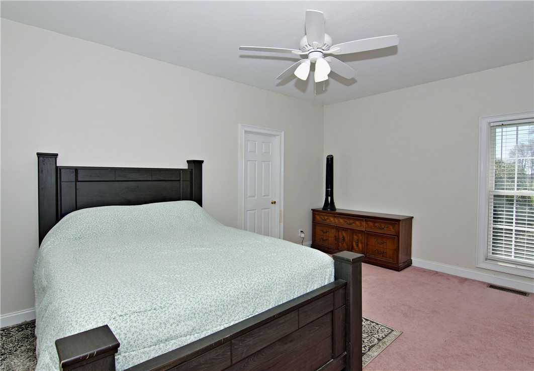 7893 Athens Road Carnesville, GA 30521 - Photo 24 of 50 Comfortable bedroom with natural light and ceiling fan offers a peaceful retreat.