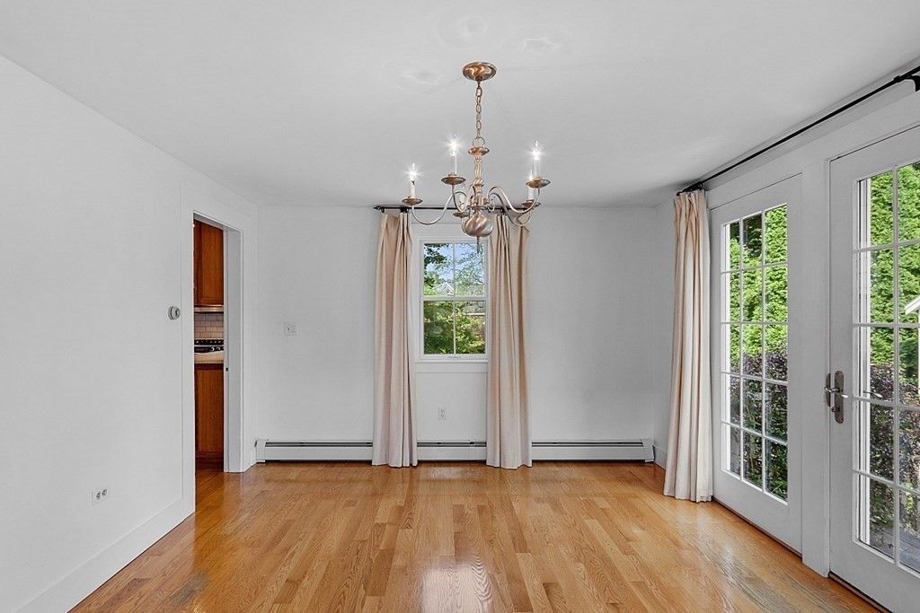 21 Cottage Street Hamilton, MA 01982 - Photo 13 of 40 a view of an empty room with wooden floor and a window