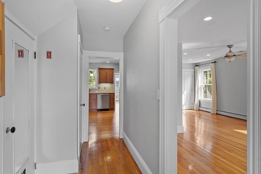 21 Cottage Street Hamilton, MA 01982 - Photo 16 of 40 a view of a hallway with wooden floor and a bathroom