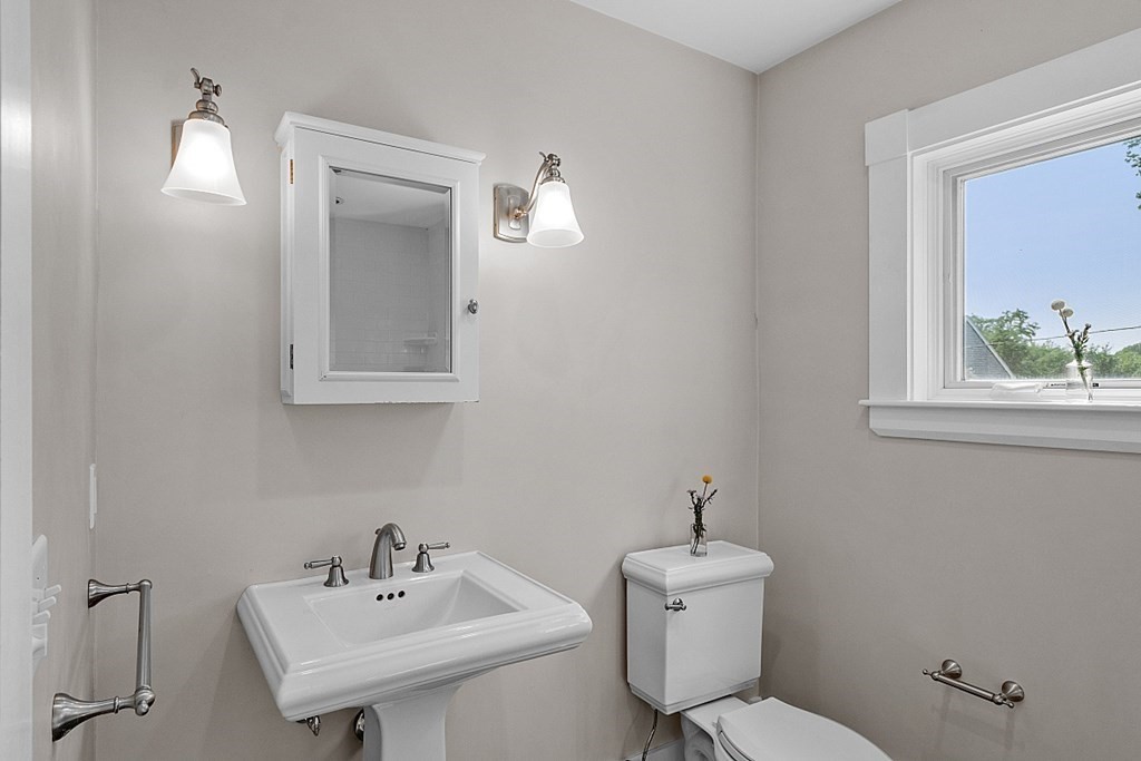 21 Cottage Street Hamilton, MA 01982 - Photo 25 of 40 a bathroom with a toilet a sink and mirror