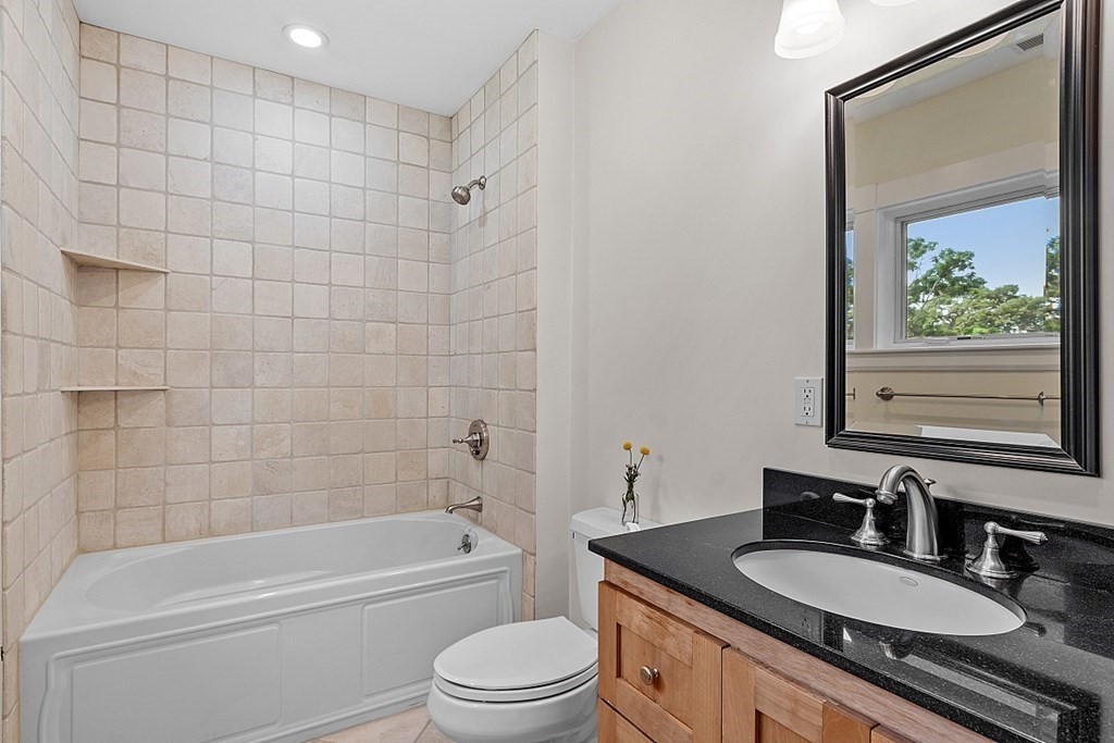 21 Cottage Street Hamilton, MA 01982 - Photo 27 of 40 a bathroom with a granite countertop sink mirror toilet and bathtub