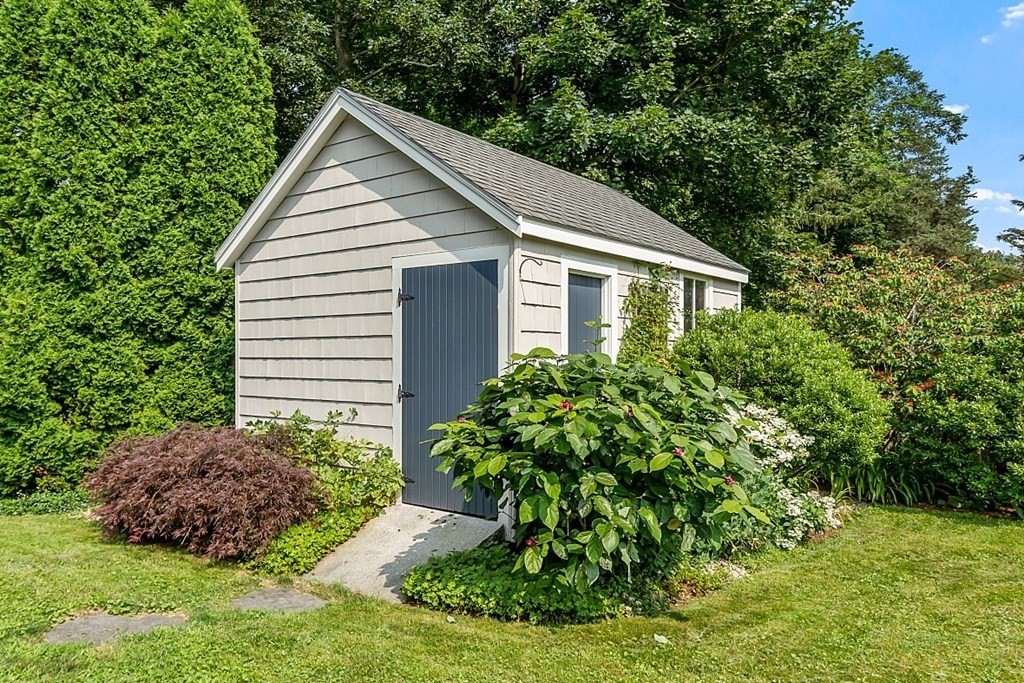 21 Cottage Street Hamilton, MA 01982 - Photo 35 of 40 a view of a house with a yard and potted plants