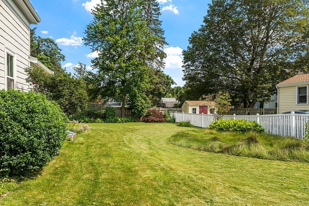 21 Cottage Street Hamilton, MA 01982 - Photo 39 of 40 a yellow house with trees in front of it