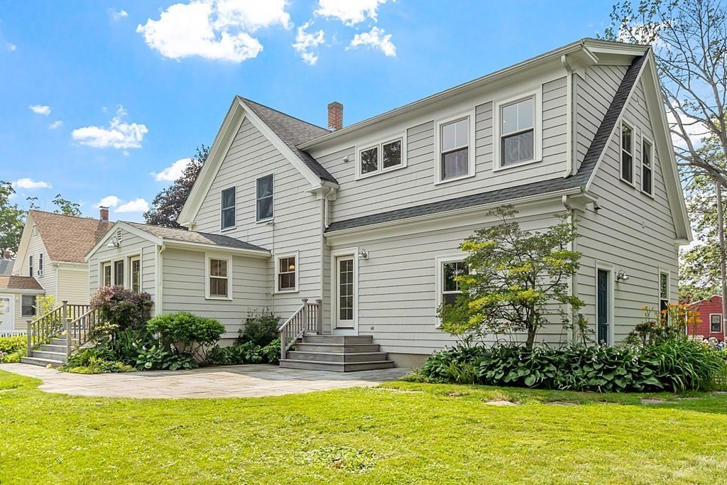 21 Cottage Street Hamilton, MA 01982 - Photo 40 of 40 a front view of a house with a yard and potted plants