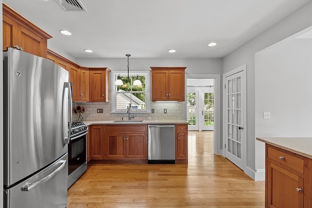 21 Cottage Street Hamilton, MA 01982 - Photo 4 of 40 a kitchen with stainless steel appliances granite countertop a refrigerator and a sink