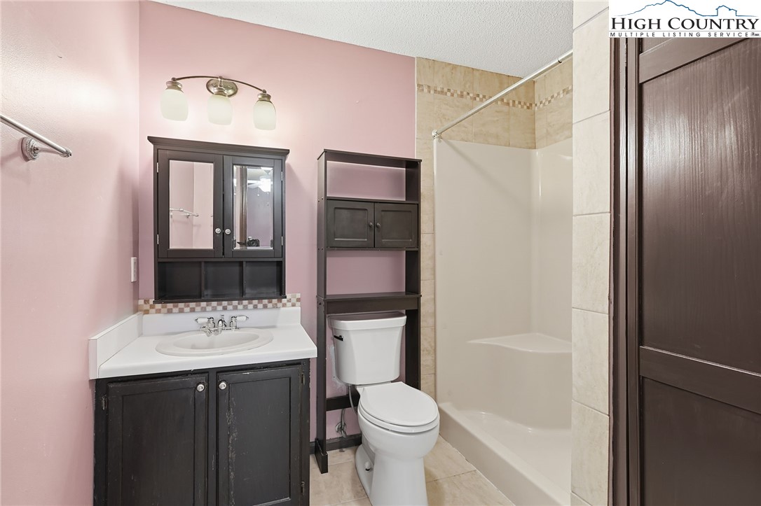 155 Glen Burney Road, Unit C4 Blowing Rock, NC 28605 - Photo 11 of 15 a bathroom with a sink a toilet and shower