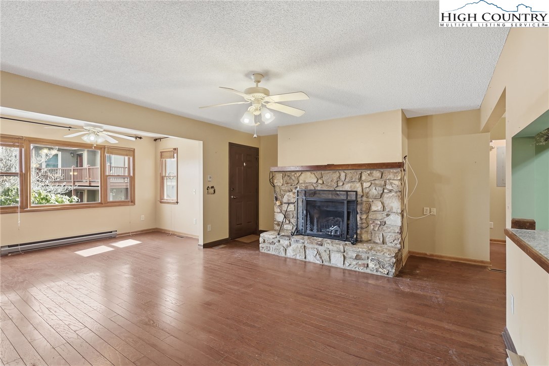 155 Glen Burney Road, Unit C4 Blowing Rock, NC 28605 - Photo 4 of 15 a view of an empty room with a fireplace and a window