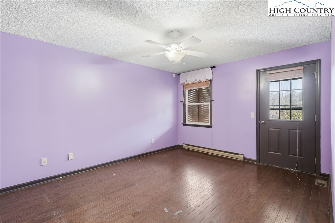 155 Glen Burney Road, Unit C4 Blowing Rock, NC 28605 - Photo 10 of 15 a view of a livingroom with wooden floor and a ceiling fan