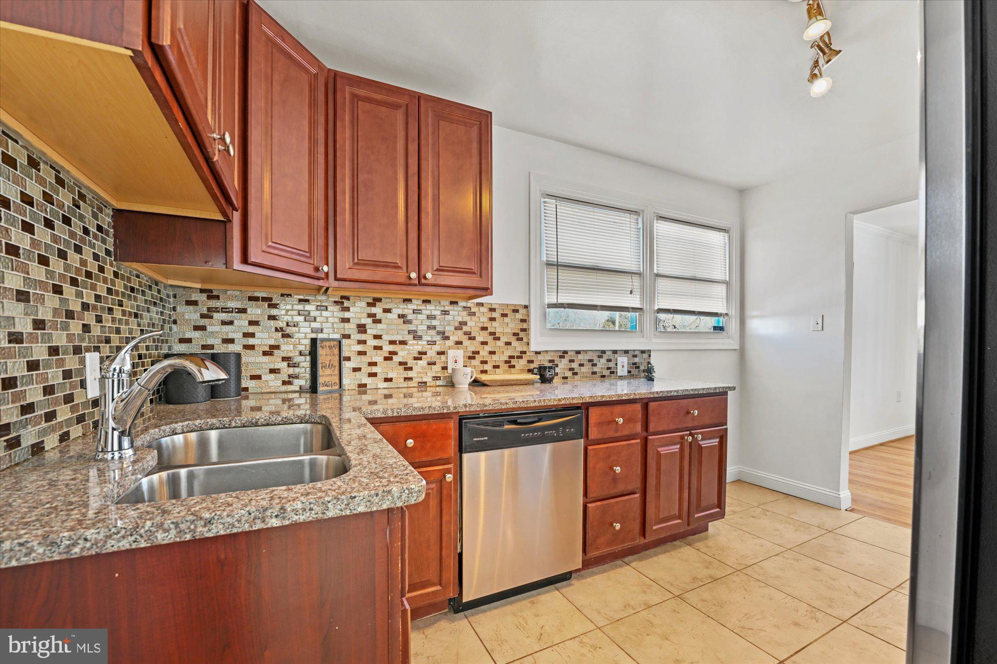 125 Allgate Road Owings Mills, MD 21117 - Photo 10 of 28 Kitchen with tile backsplash & updated cabinetry