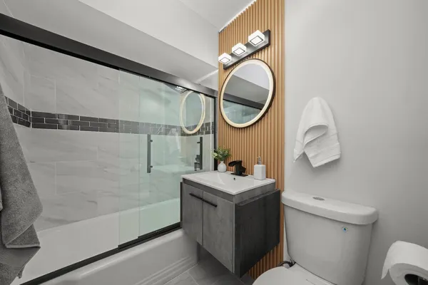a bathroom with a sink a toilet and a mirror