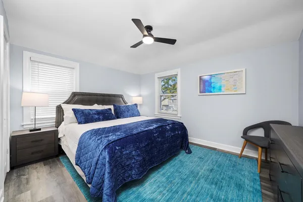 a bedroom with a bed and a desk
