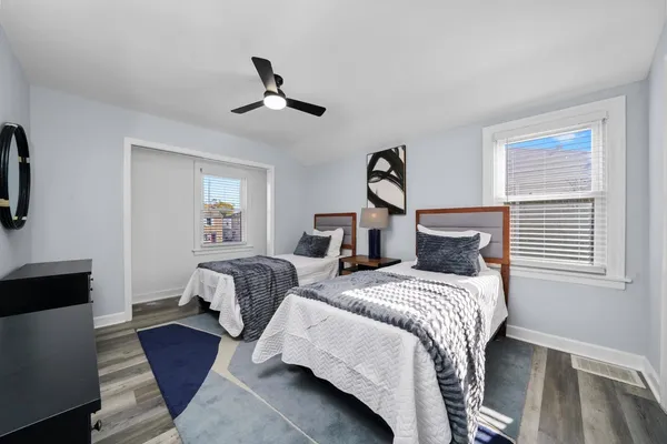 a bedroom with two beds and a chandelier