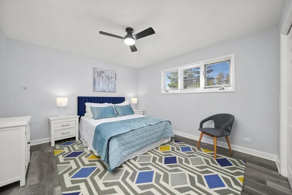 a bedroom with a bed and a painting on the wall