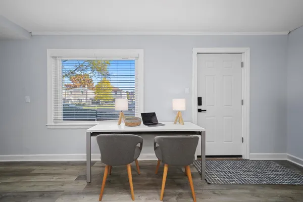 a view of a dining room with furniture window and wooden floor