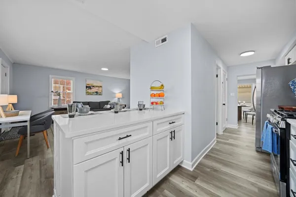 a kitchen with white cabinets and stainless steel appliances