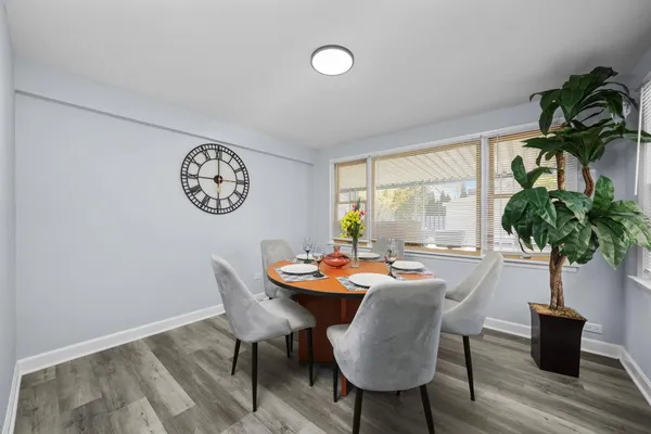 a dining room with furniture window and wooden floor