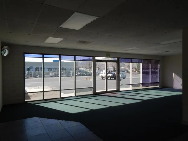 a bed sitting in a room next to a large window
