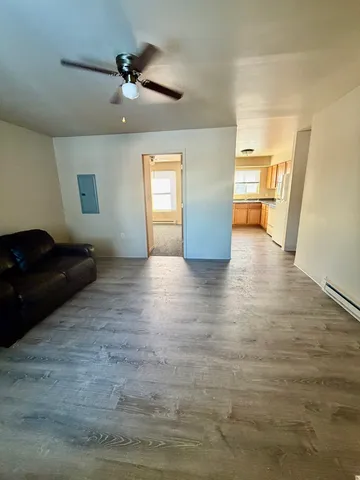 a living room with furniture and a ceiling fan