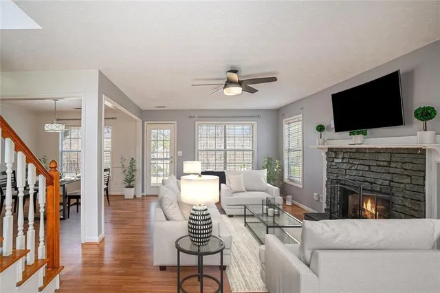 a living room with fireplace furniture and a flat screen tv