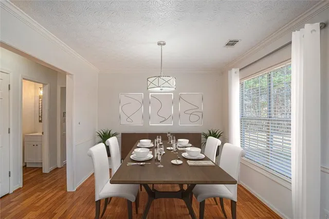 a view of a dining room with furniture window and wooden floor