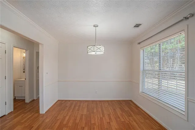 a view of a room with wooden floor and windows
