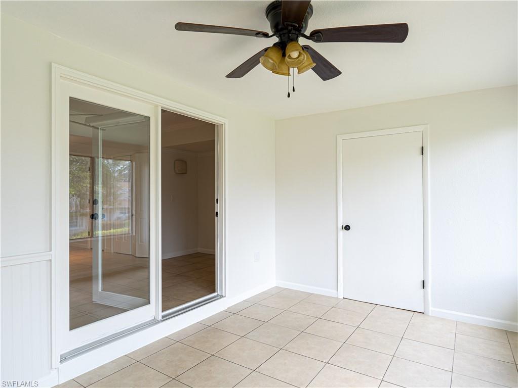 11001 Southeast Sunset Harbor Road, Unit 34 Summerfield, FL 34491 - Photo 14 of 31 Tiled empty room featuring ceiling fan