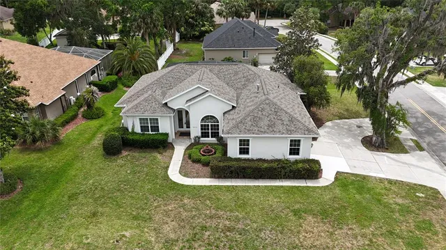 an aerial view of a house with garden space and street view