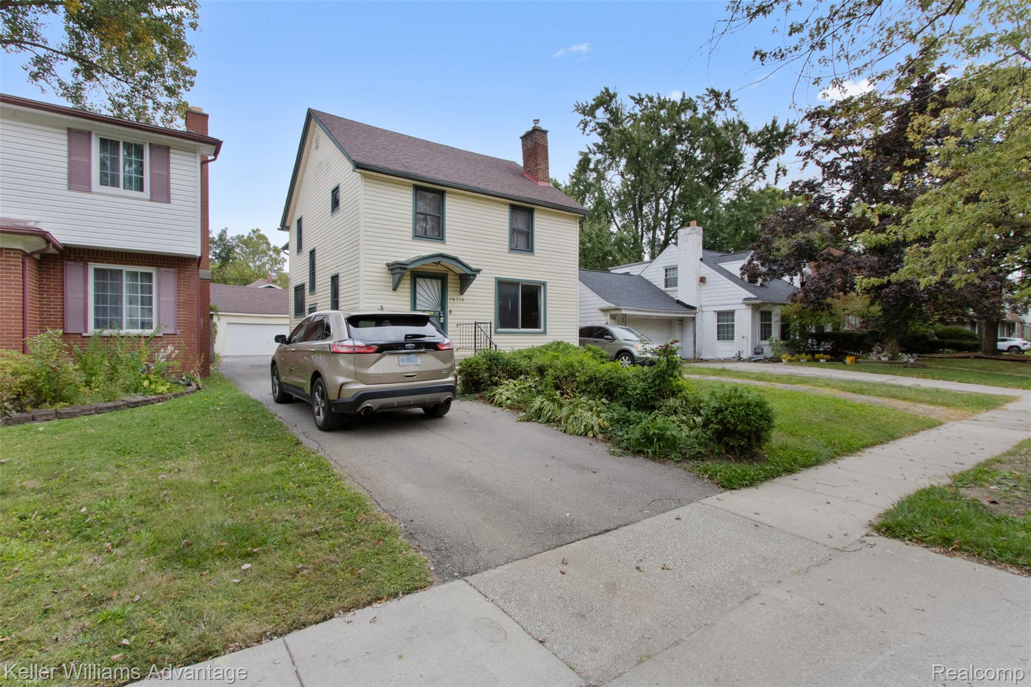 16718 Sunderland Road Detroit, MI 48219 - Photo 1 of 19 View of front of house featuring a front yard, a chimney, and a garage