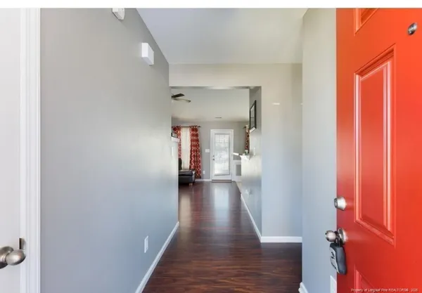 a view of a hallway with wooden floor
