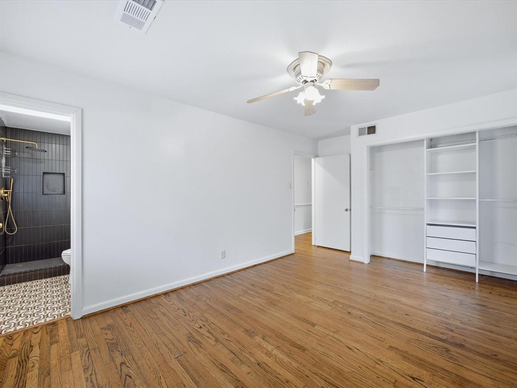 514 West Ridgewood Drive Garland, TX 75041 - Photo 9 of 39 Primary bedroom with light wood-style floors, ensuite bath, ceiling fan, and a closet