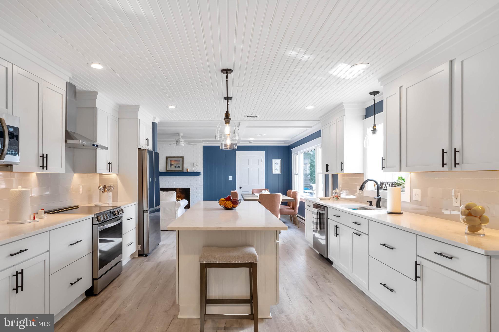 31394 Point Circle Lewes, DE 19958 - Photo 34 of 79 a large kitchen with stainless steel appliances kitchen island granite countertop a lot of counter space and wooden floors