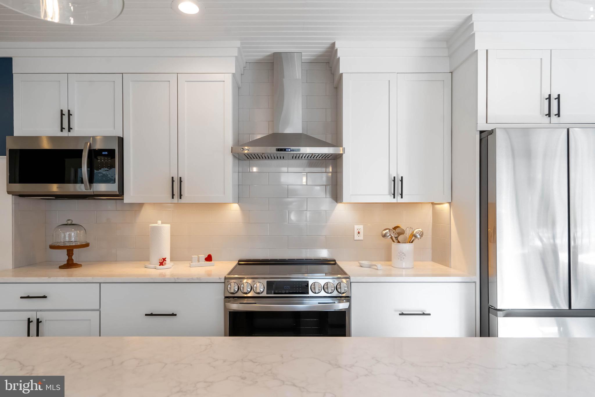 31394 Point Circle Lewes, DE 19958 - Photo 40 of 79 a kitchen with stainless steel appliances a stove and a refrigerator