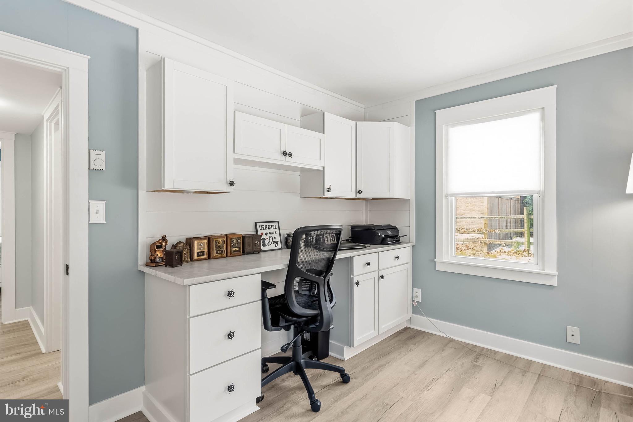 31394 Point Circle Lewes, DE 19958 - Photo 64 of 79 a kitchen with stainless steel appliances granite countertop a stove a sink a refrigerator and white cabinets with wooden floor