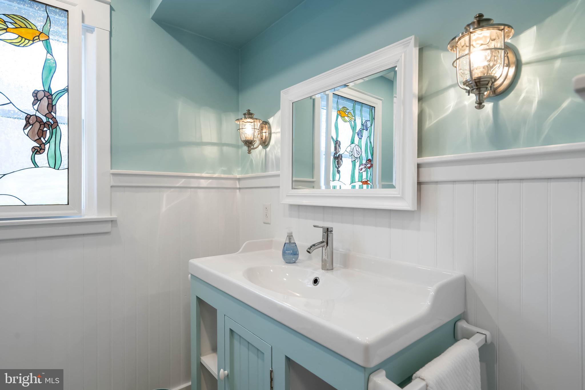 31394 Point Circle Lewes, DE 19958 - Photo 66 of 79 a bathroom with a sink and a mirror