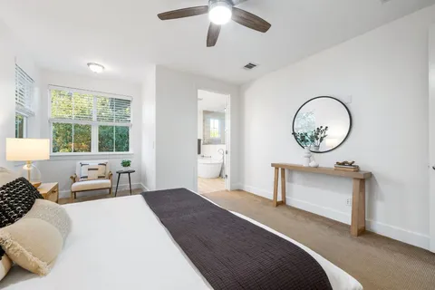 a bathroom with a granite countertop toilet a sink and a mirror