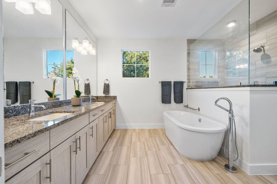 7906 Ryans Way Austin, TX 78726 - Photo 14 of 32 Primary bathroom with soaking tub and shower with dual vanity.
