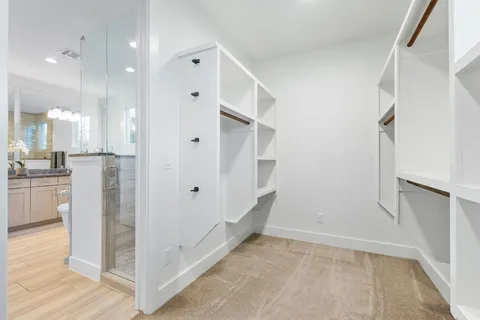a bathroom with a double vanity sink a mirror and a shower