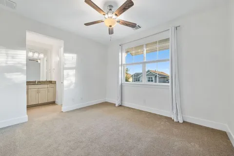 a view of a hallway with wooden floor and entryway