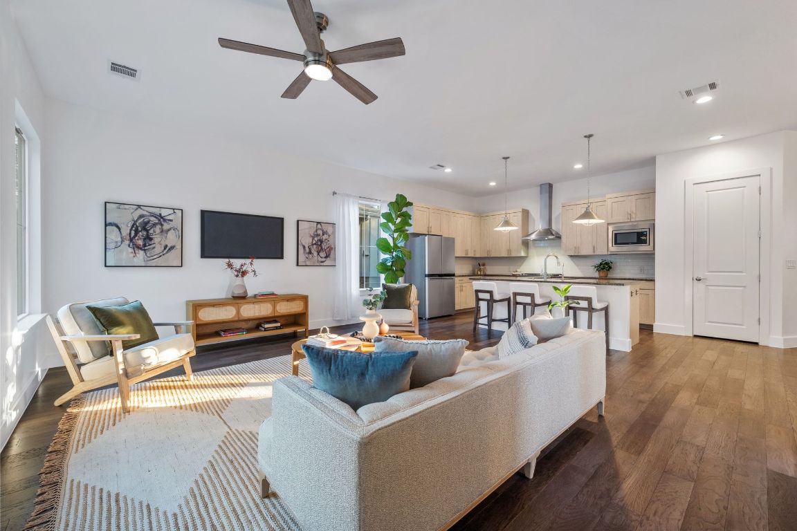The living room has lot of natural light and plenty of living space with gorgeous wood floors.