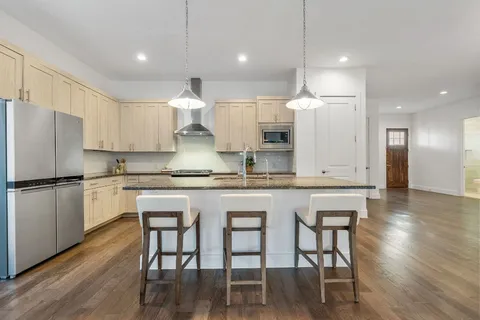 a living room with furniture and a kitchen view