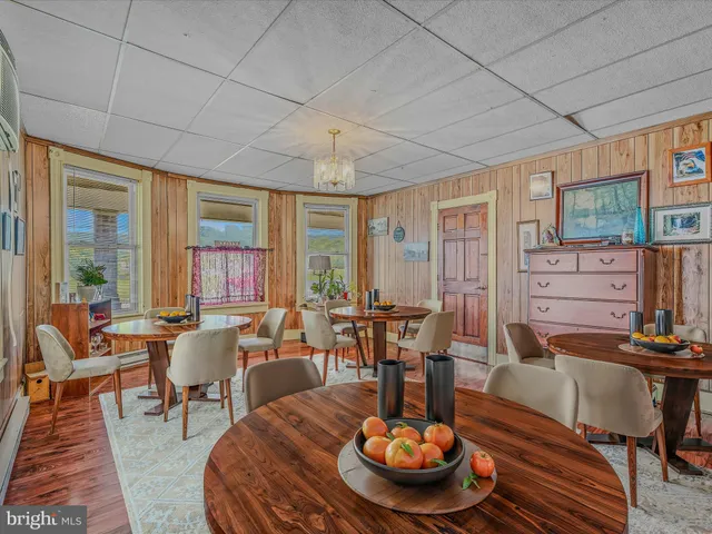 a dining room with furniture window and wooden floor