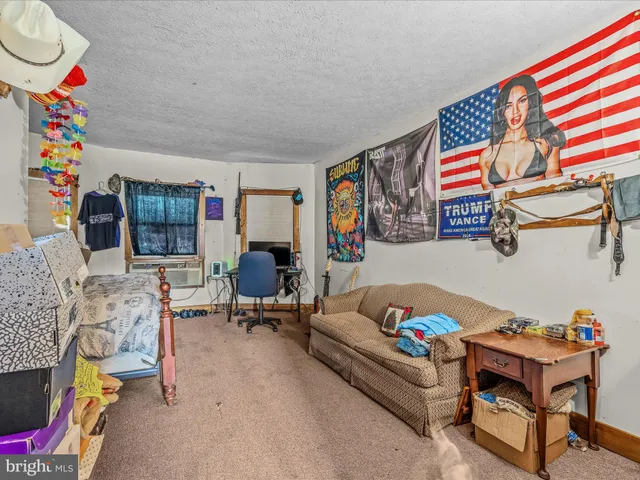 a bed room with furniture and a flat screen tv